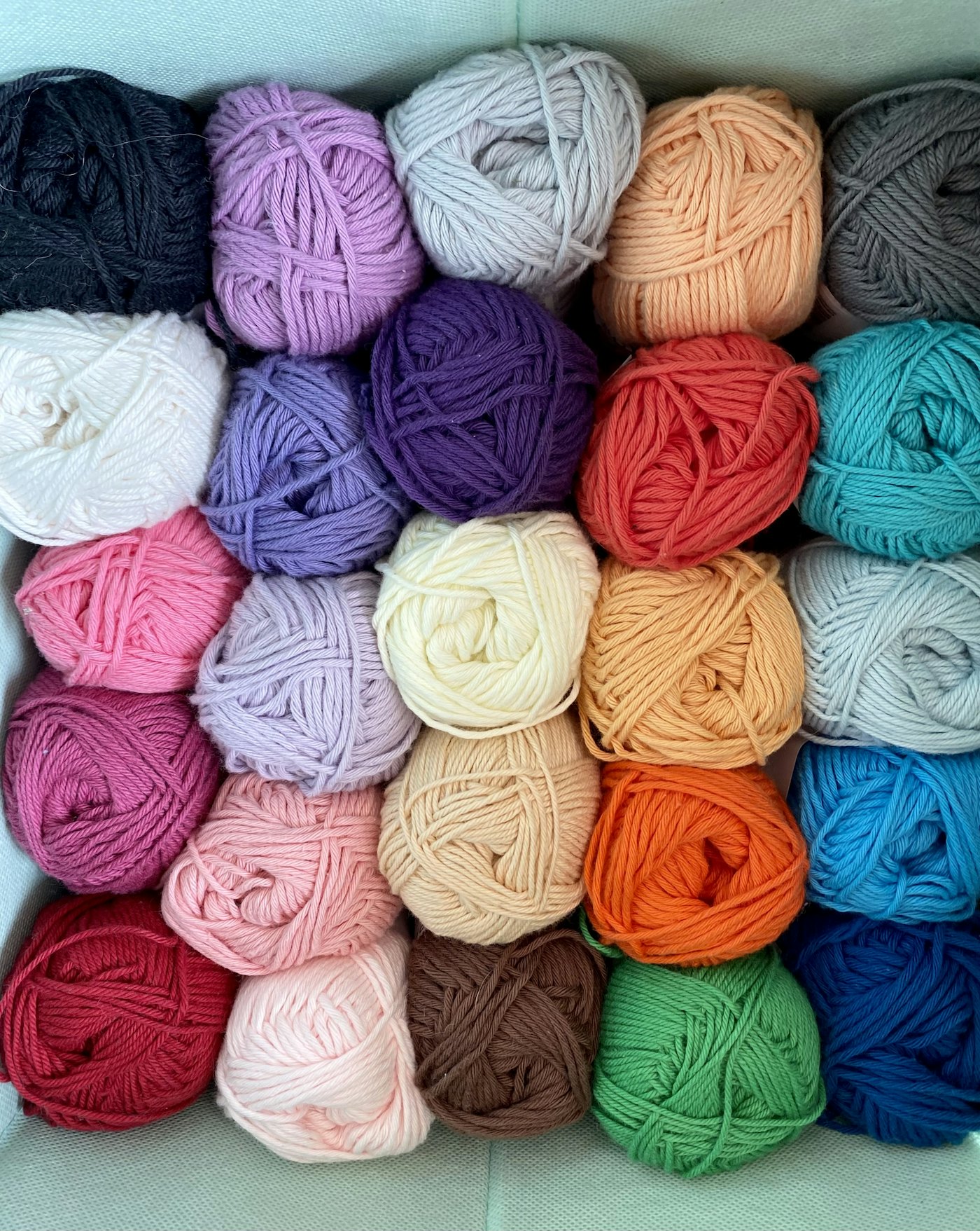 Balls of yarn in many colors arranged in a grid